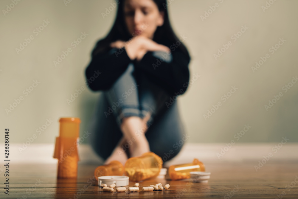 Caucasian female contemplating take prescription pills